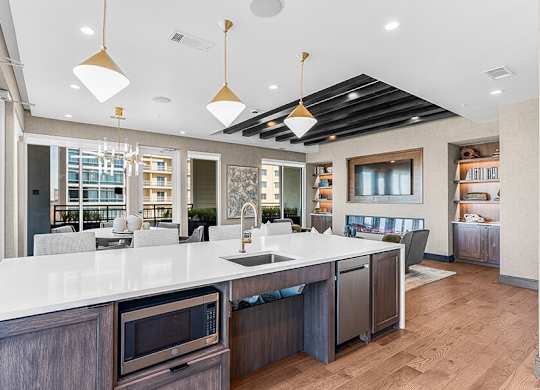 Community Clubhouse with Kitchenette at Ovation at Galatyn Park Apartments located in Richardson, TX.