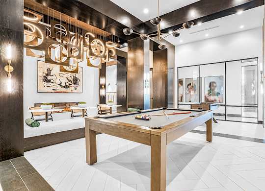 Community Clubhouse with Game Tables at Ovation at Galatyn Park Apartments located in Richardson, TX.