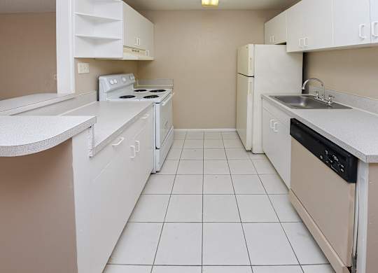 A small kitchen with white appliances and cabinets.
