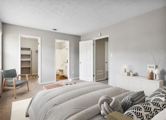 Model apartment bedroom with a large bed and a closet