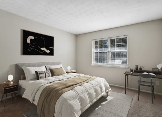 Model apartment bedroom with a bed and a desk and a window