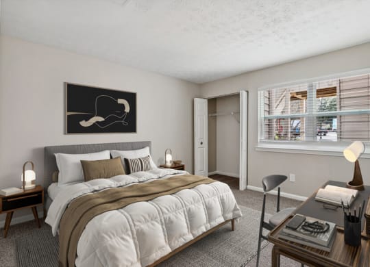 Model apartment bedroom with a bed and a desk and a window