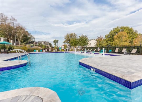 Swimming pool with cabanas and lounge chairs