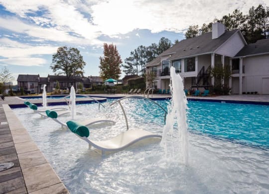 Swimming pool with cabanas and lounge chairs