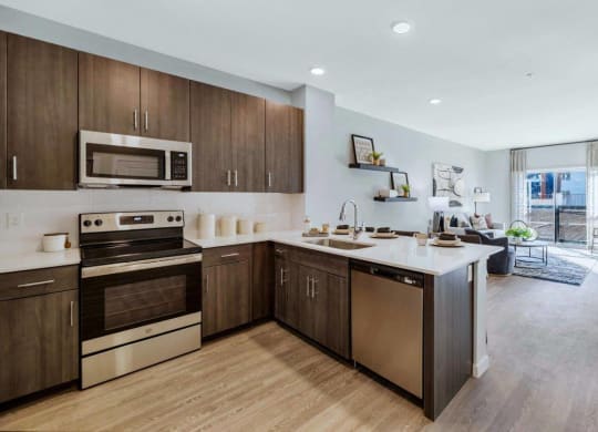 Model kitchen with stainless steel appliances at Glen 91 Apartments in Glendale, AZ