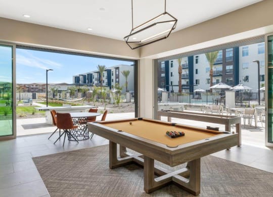 Resident lounge space with billiards table at Glen 91 Apartments in Glendale, AZ