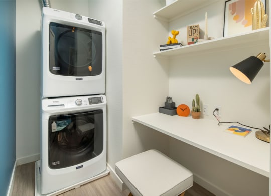 a washer and dryer are stacked on top of each other in a laundry room