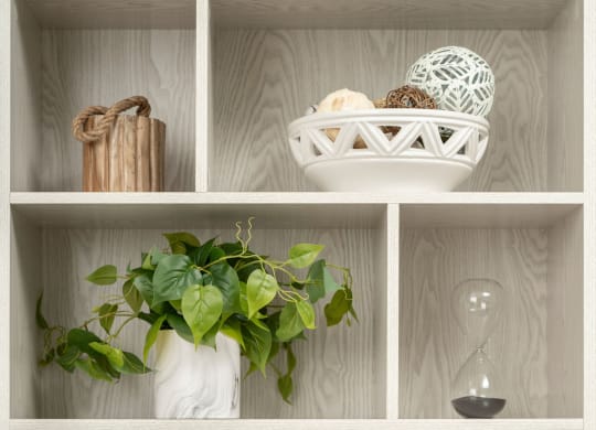 a bookcase with books and decorations on it