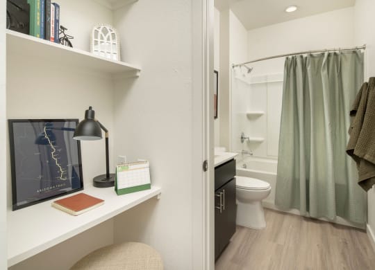 a bathroom with a white toilet next to a green shower curtain