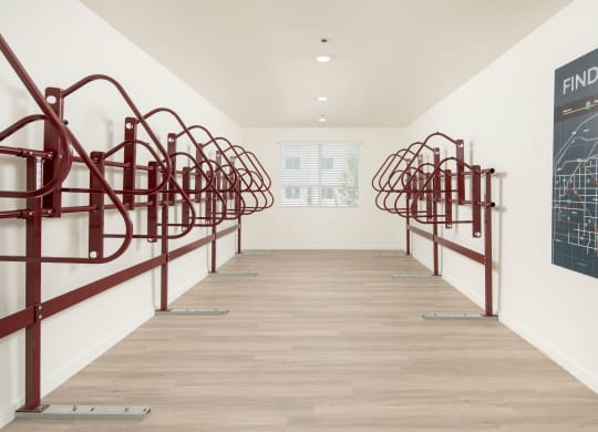 a long hallway with red metal railings and a blackboard on the wall