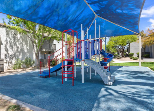 a playground with a blue and red slide