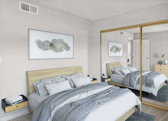 Model bedroom with a bed and a large mirror