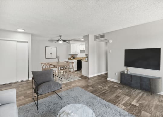 Model apartment living room with a couch a coffee table and a flat screen tv
