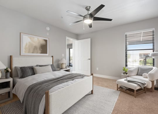 Model apartment bedroom with a bed and a ceiling fan at Harmony at Surprise, Surprise, Arizona, 85379