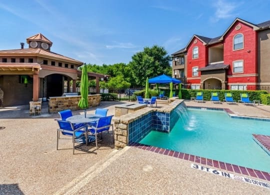 Swimming pool with cabanas and lounge chairs at Hidden Creek, Lewisville, Texas