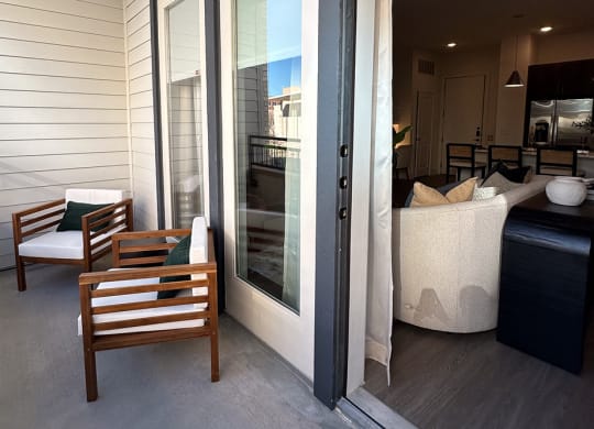a porch with a couch and chairs and a sliding glass door