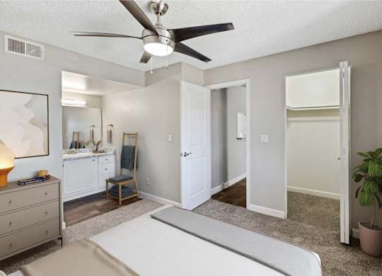 a bedroom with a bed and a ceiling fan