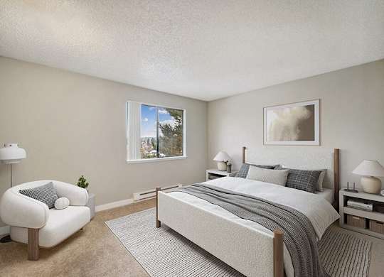 Model Bedroom with Carpet and Window View at Grammercy Apartments located in Renton, WA.