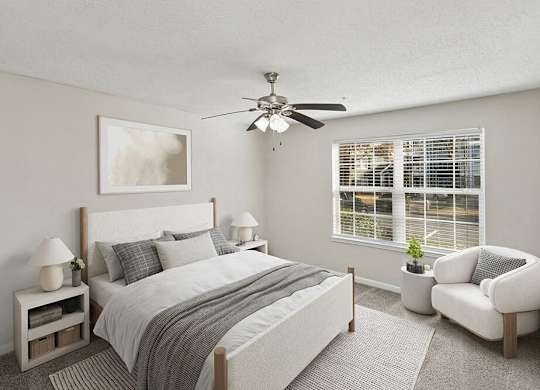 Model Bedroom with Carpet and Window View at Shadow Ridge Apartments in Riverdale, GA.