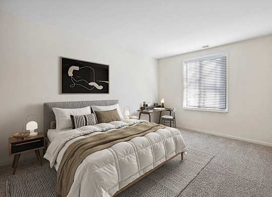 Apartments for Rent in Silver Spring, MD - Spring Parc - Bright Bedroom With Upholstered Bed, Neutral Bedding, Side Tables, Desk Nook, And Wide Window With Blinds Over Plush Carpet