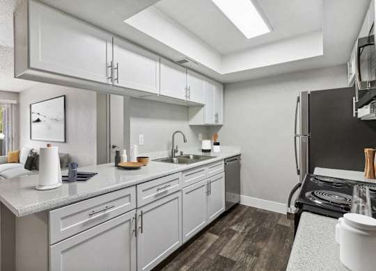 a kitchen with white cabinets and stainless steel appliances