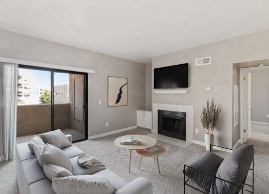 Model living room with fireplace and private patio