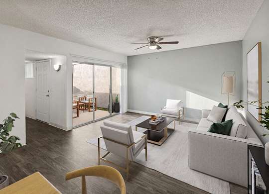 Three-Bedroom Affordable Apartments in East Tucson, AZ - Lakeside Casitas - A Living Room With Sofa, Armchairs, Coffee Table, Ceiling Fan, And Sliding Glass Doors Leading to Private Courtyard.