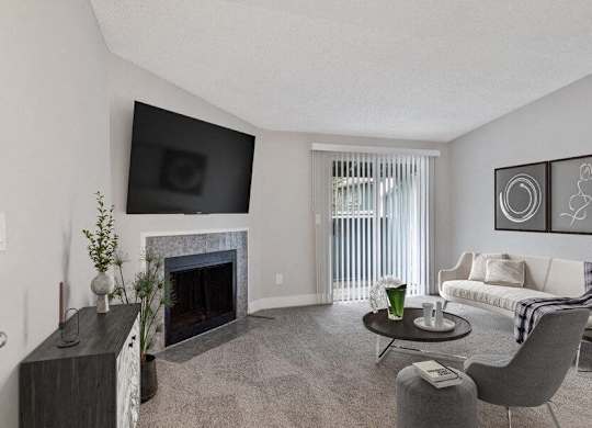 Federal Way, WA, Pet-Friendly Apartments - Sunset Three Twenty - A Living Room With A Wall-Mounted TV Above A Fireplace, A Sofa, Chairs, A Round Coffee Table, And Wall Art.