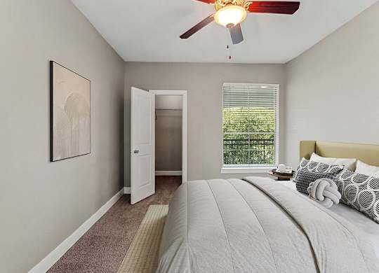 Model Bedroom with Carpet and Walk In Closet at Park West Apartments located in Houston, TX.