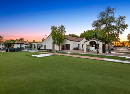 a yard with a golf course and a house in the background at Lore South Mountain, Phoenix, AZ