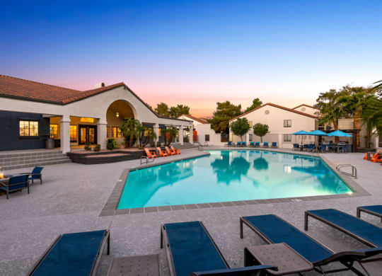 a swimming pool with lounge chairs around it in front of a building at Lore South Mountain, Phoenix, AZ, 85044