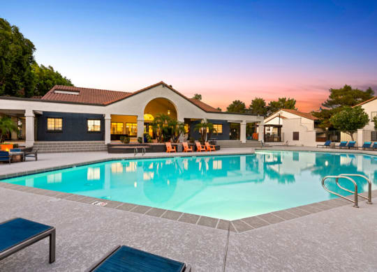a swimming pool in front of a house with a resort style pool at Lore South Mountain, Phoenix, AZ