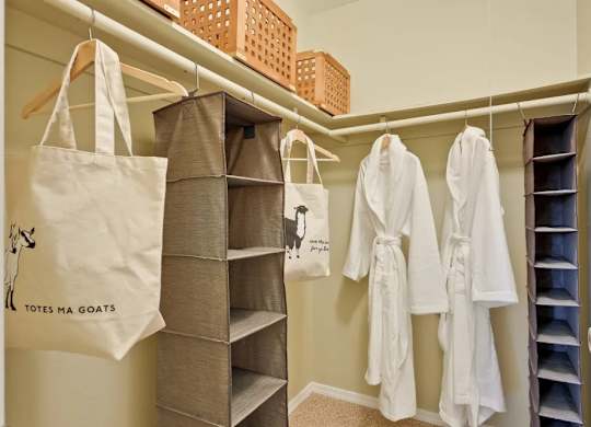 A bathroom with a tote bag that says "Totes Ma Goats" hanging on the wall.
