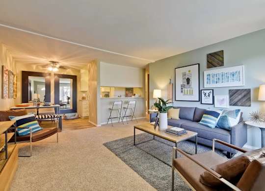 A living room with a grey couch and a brown chair.