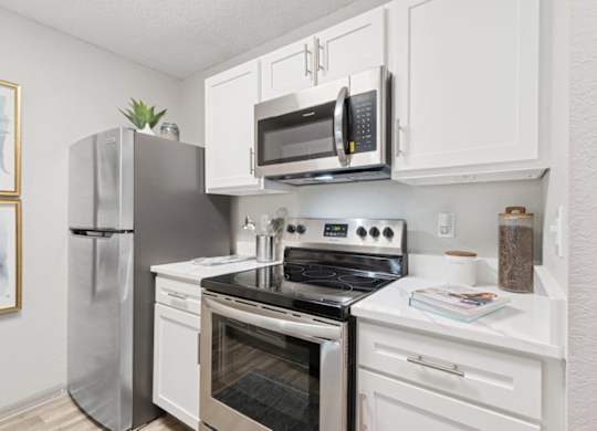 Model kitchen with stainless steel appliances at Mirage on Kernan Apartments in Jacksonville, FL