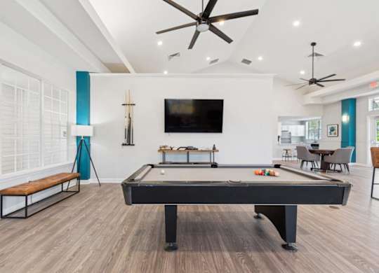 Resident lounge with TV and billiards table at Mirage on Kernan Apartments in Jacksonville, FL