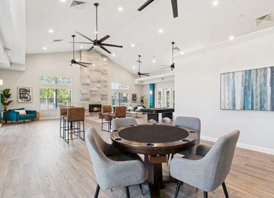 Community lounge with tables at Mirage on Kernan Apartments in Jacksonville, FL