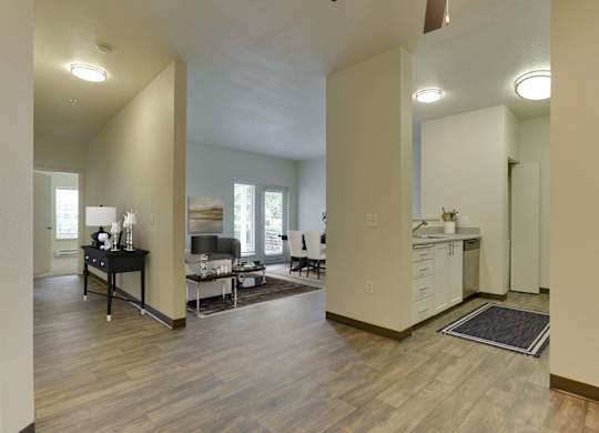 Model Kitchen with White Cabinets and View of Living Room at Landings at Morrison Apartments located in Gresham, OR.