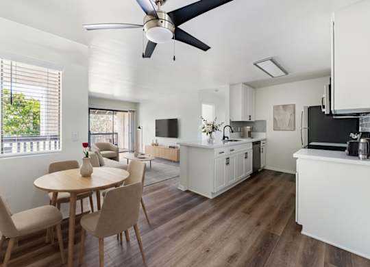 A modern kitchen with a dining table and chairs.