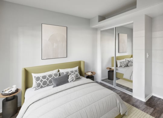 a bedroom with a large bed and a mirror