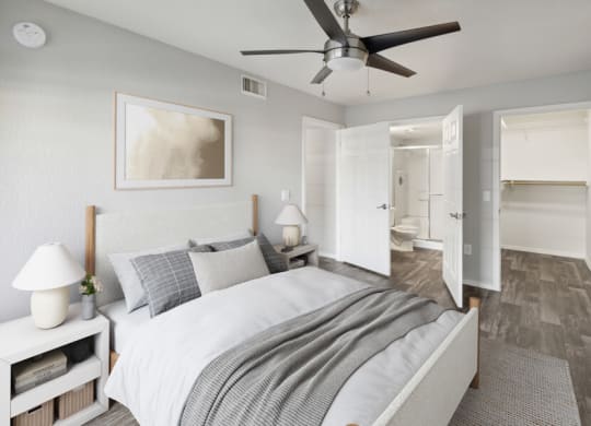 a bedroom with a ceiling fan and a bed