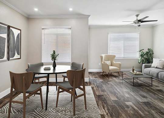 A dining room with a round table and chairs.