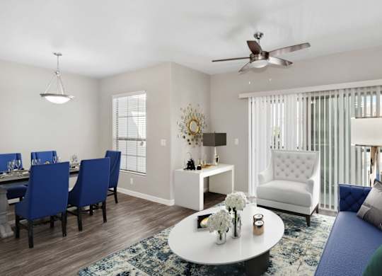 A living room with a dining table and chairs.