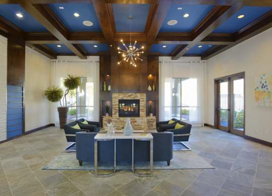 A large, open living room with a fireplace and a dining table set up.