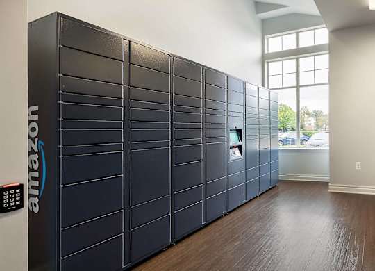 A row of Amazon lockers are lined up in a room.