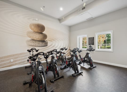 a room filled with lots of bikes and a circular structure in the middle of the room