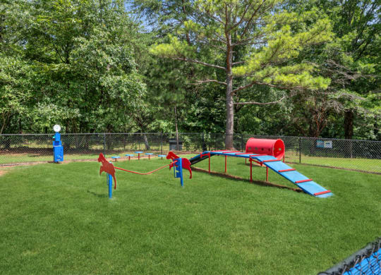 a playground with a slide and agility ropes