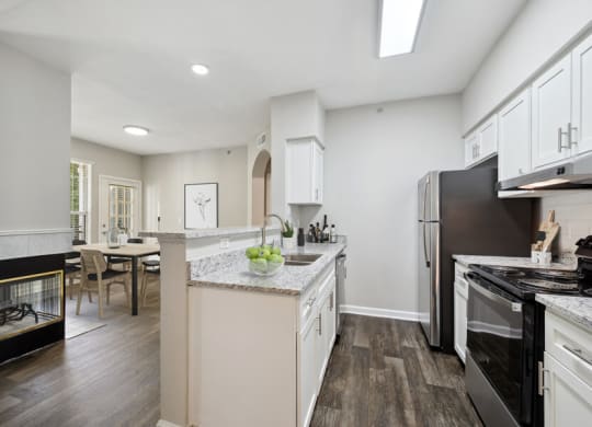 a kitchen with white cabinets and a black stove top oven