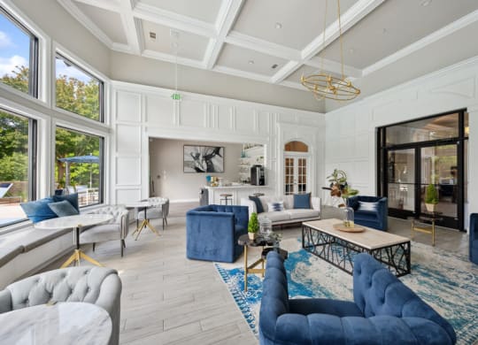 a living room with white walls and a coffered ceiling