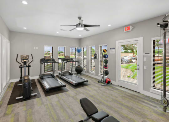 Community gym with treadmills and a ceiling fan